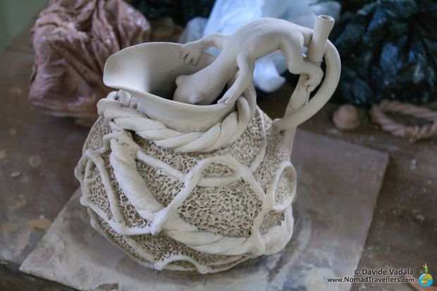 Gecko drinking from a pitcher