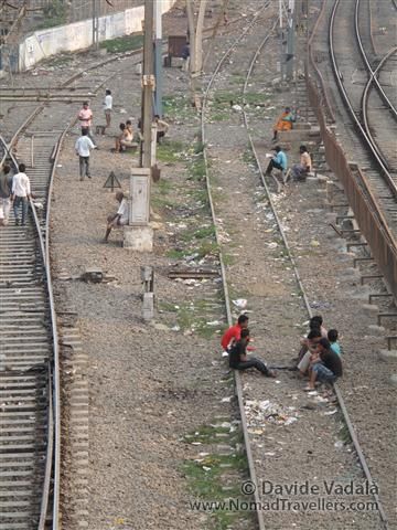 In a place where space and light is of limited access, the rails are used as a comfortable living room. 002 Mumbai-Bombay-Dharavi-Slum India 3947