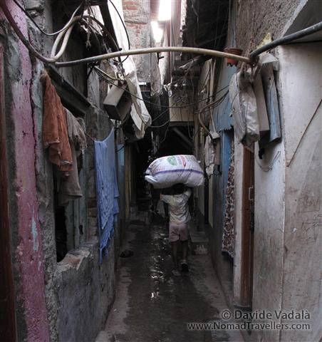 While some kids are studying, lots of them are working to help economically their families. 048 Mumbai-Bombay-Dharavi-Slum India 3932