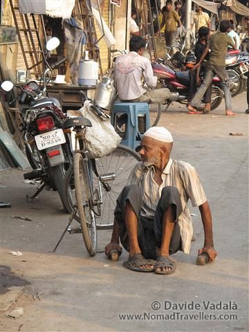 As everywhere in India, there isn't much support for disabled people. A man unable to walk is crawling in the asphalt. 051 Mumbai-Bombay-Dharavi-Slum India 3939