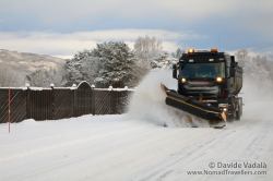 A snow-plough in action to clean the road