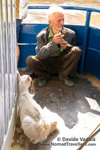 A local passenger on the boat with his goat