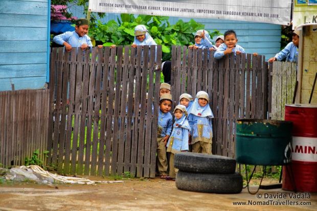 School kids staring at us while hitchhiking out of Kota Bagun