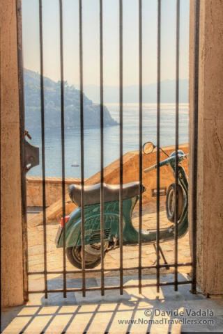 Italy in a Nutshell: the golden sun lightning the sea behind a Vespa in Scilla, Calabria